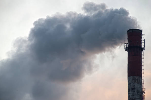 istock Pipe with smoke on a background of the sky close-up, with copy space. 903072838