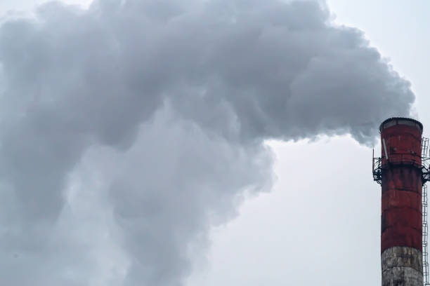 istock Pipe with smoke on a background of the sky close-up, with copy space. 903072844
