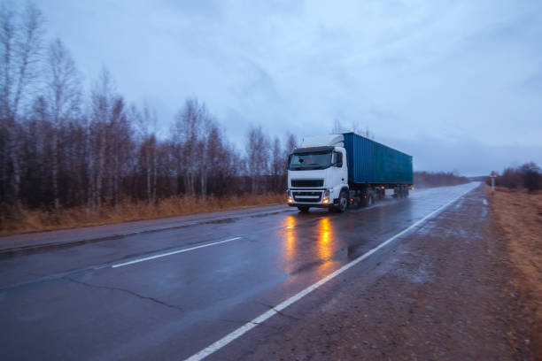 istock White truck on a road in rainy day 903072870