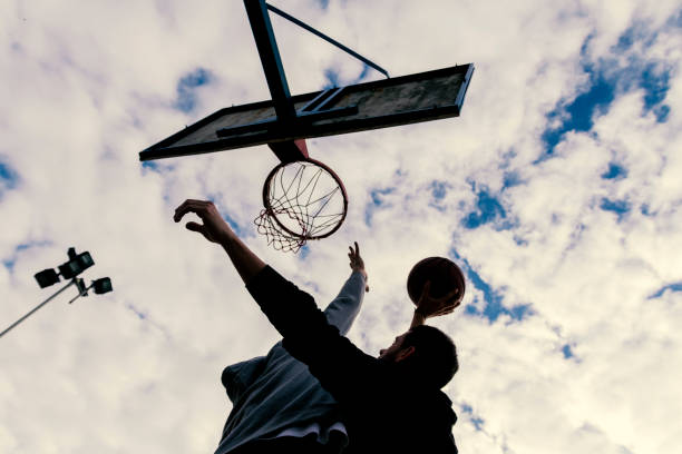 istock Two basketball players playing a friendly game 903073528