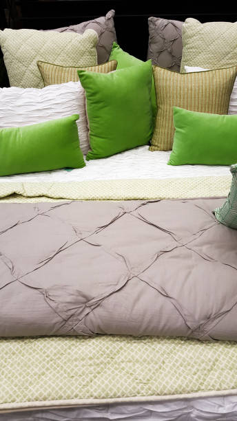 istock Bed with green and grey soft furnishings 903080256