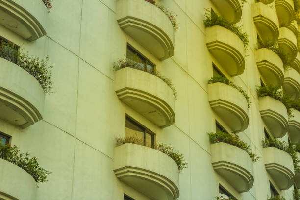 Beautiful architecture design pattern of terrace. Many Windows and balcony on residential building hotel. Hotel apartment balcony texture pattern. Exterior design of rows of balconies