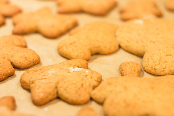 istock Ginger biscuits lie on a baking sheet. Cookies on baking paper. Selective focus. 903082112