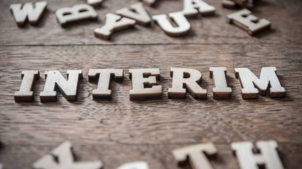 concept wooden word on wooden table - Interim concept wooden word on wooden table background - Interim temporary stock pictures, royalty-free photos & images