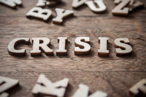 concept wooden word on wooden table - crisis - declaring bankrupcy imagens e fotografias de stock