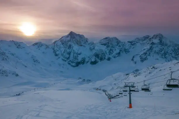 Aerial view of vivid beautiful sunset over snowy ski resort, Solda (Sulden), South Tyrol, Italy