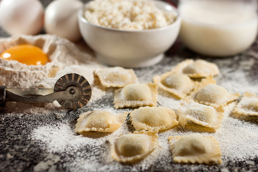 Italian food home made pasta ravioli on granite background