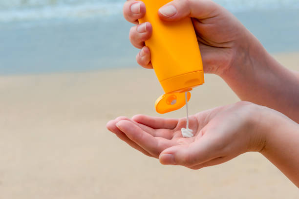 istock close-up of women's hands with sunscreen 903105200