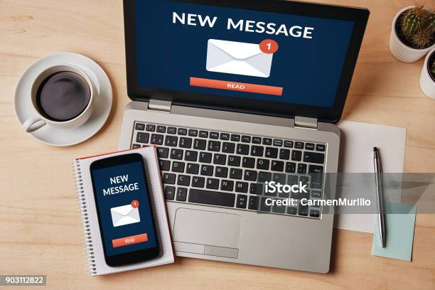 New Message Notification Concept On Laptop And Smartphone Screen Stock Photo - Download Image Now