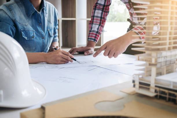 istock Architect working on blueprint, Engineer meeting working with partner colleagues and engineering tools for architectural project, Construction concept 903119434