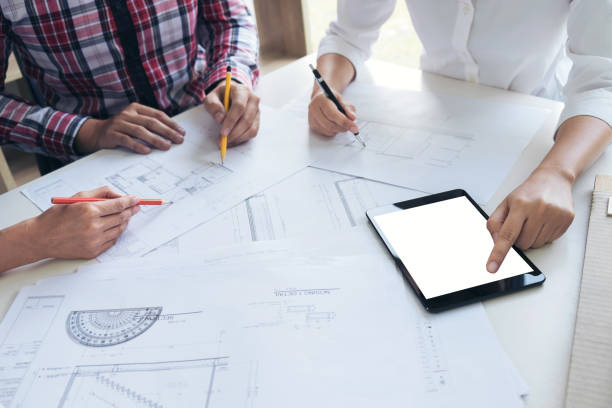 istock Architect working on blueprint, Engineer meeting working with partner colleagues and engineering tools for architectural project, Construction concept 903119436