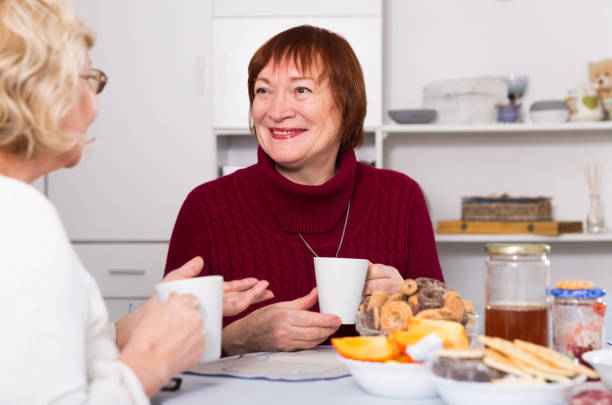 istock Positive old women drinking tea at the table 903120848