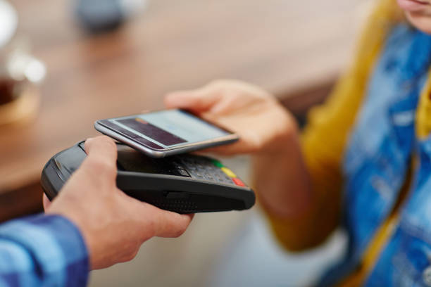 istock Woman making wireless payment from gadget 903124482