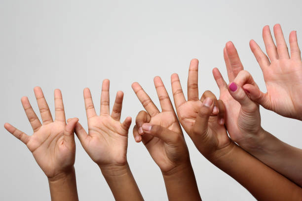 istock many raised children's expressive hands in a row 903135022