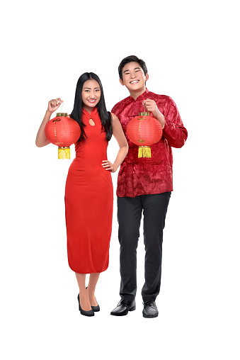 Portrait of chinese couple holding red lanterns posing isolated over white background
