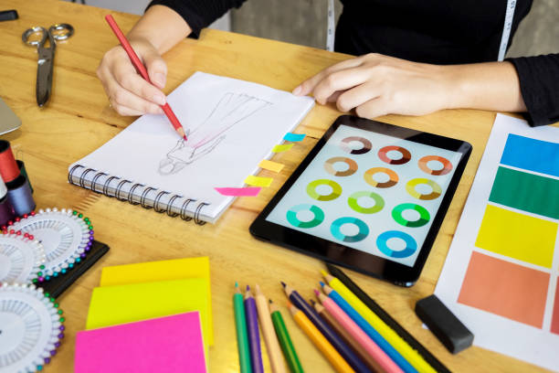 istock Close-Up Of Hand Drawing On Note Pad With Digital Tablet At Table 903149536
