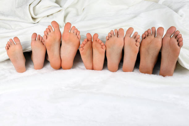 istock children's feet peeking from under the blanket 903157050
