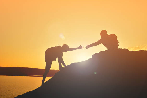 istock Friends On Rock At Beach Against Sky 903158060