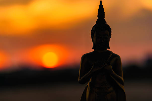istock Silhouette buddha statues on blurred sunset background.Thailand. 903158218