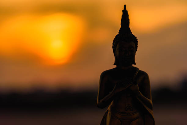 istock Silhouette buddha statues on blurred sunset background.Thailand. 903158504