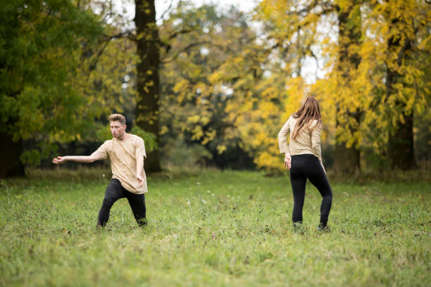 istock Young Couple Dancing On Grassy Field At Park 903164354