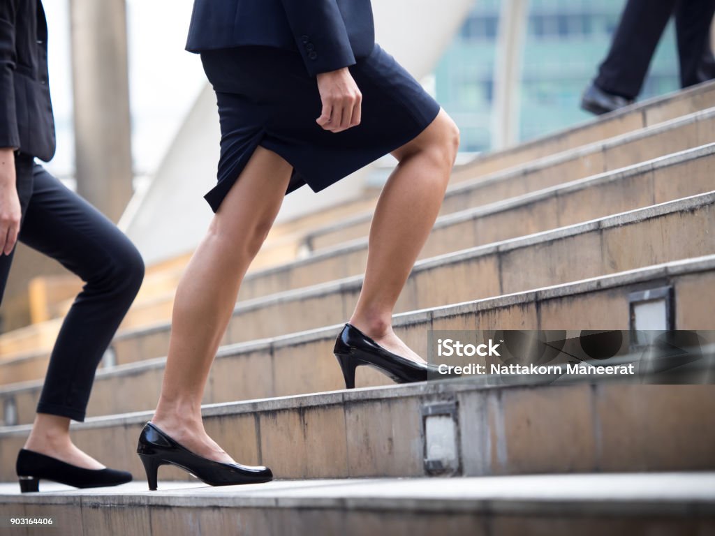 Close up legs of businesswoman walking stepping up stair in modern city, business growth, go up, success, grow up business concept Ladder of Success Stock Photo