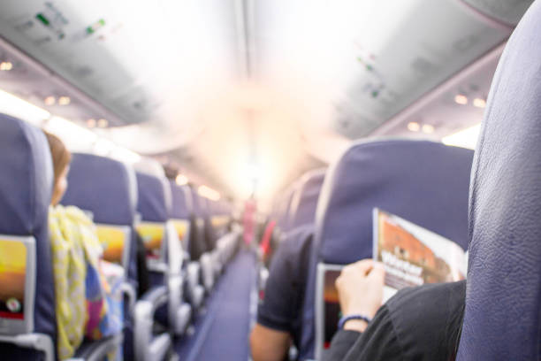 istock Interior of airplane with stewardess and passengers  on seats 903165970