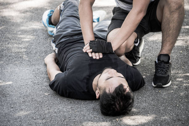 istock A man making cardiopulmonary resuscitation to an unconscious guy after heart attack while exercising in a park. 903168502