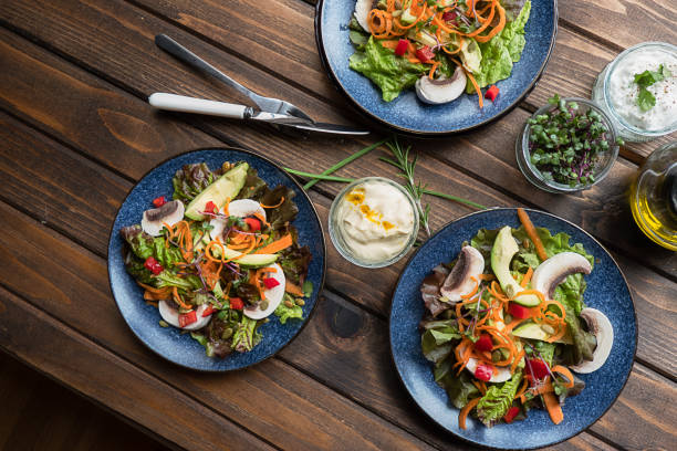 istock Winter salad, 3 blue plates brown background 903176970