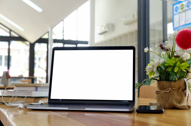 istock Mock up laptop on a wood table. 903179768