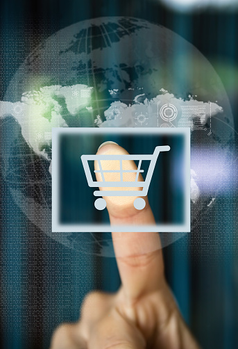 A woman is shopping at the online store. Shopping cart icon. E-commerce.