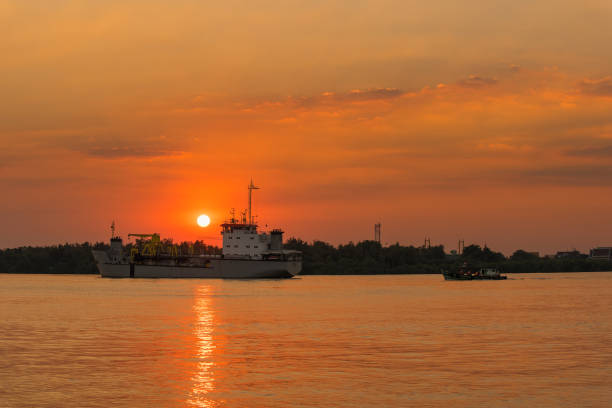istock Cargo ship in the Chao Phraya River at estuary in sunsrt time at Samut Prakan, Thailand. 903184538