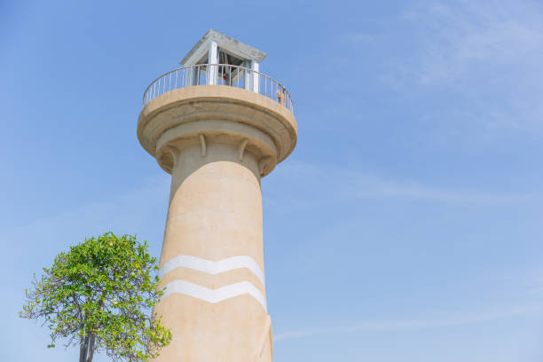 istock lighthouse day clear blue sky summer season with small tree 903187466