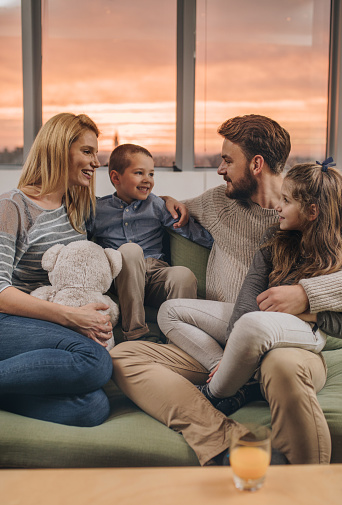 Happy Parents Talking To Their On At Home Stock Photo - Download Now - iStock