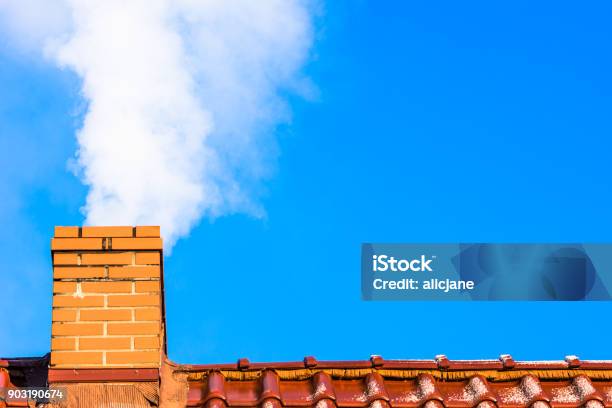 Modern House Roof With Chimney Smoke Air Pollution And Smog In Winter Ecological Issues Stock Photo - Download Image Now