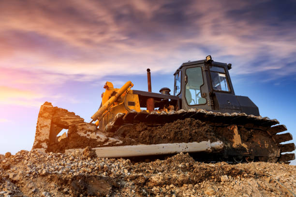 istock bulldozer at construction site and sunrise landscape 903192846