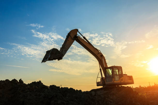istock excavator working on construction site and sunrise landscape 903193964