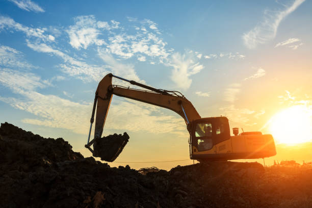 istock excavator working on construction site and sunrise landscape 903194182