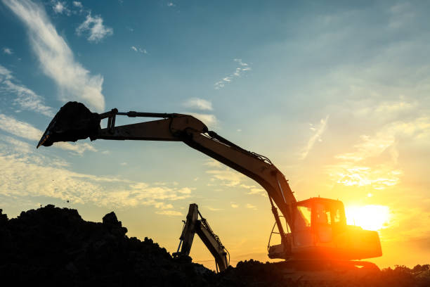 istock excavator working on construction site and sunrise landscape 903194224