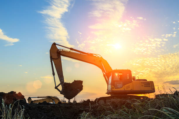 istock excavator working on construction site and sunrise landscape 903194226