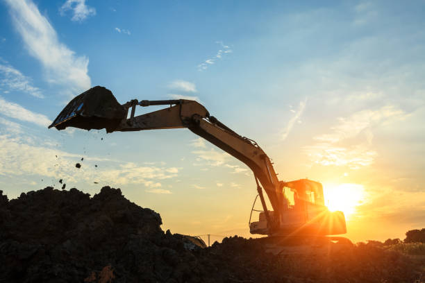 istock excavator working on construction site and sunrise landscape 903194364