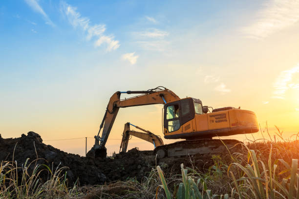 istock excavator working on construction site and sunrise landscape 903194518