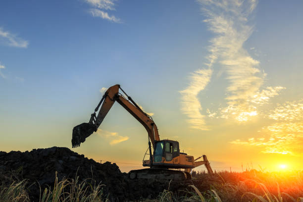 istock excavator working on construction site and sunrise landscape 903194660