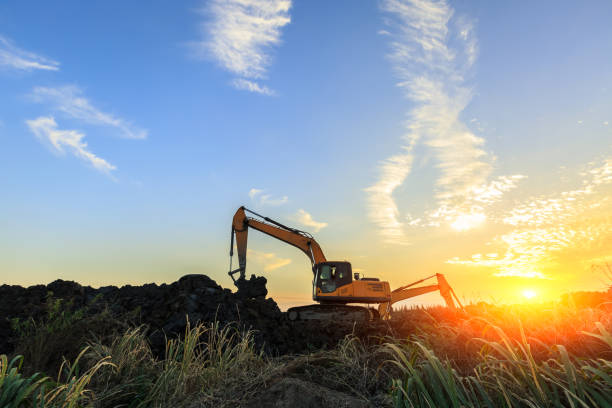 istock excavator working on construction site and sunrise landscape 903194856