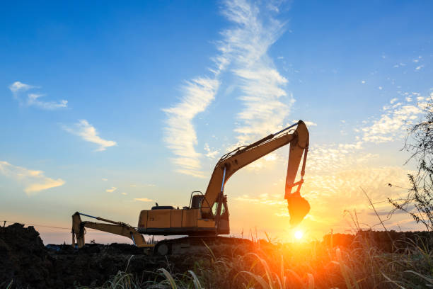 istock excavator working on construction site and sunrise landscape 903194992