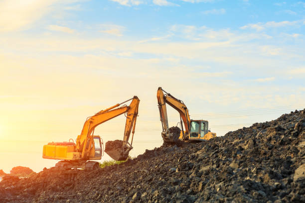istock excavator working on construction site and sunrise landscape 903195084