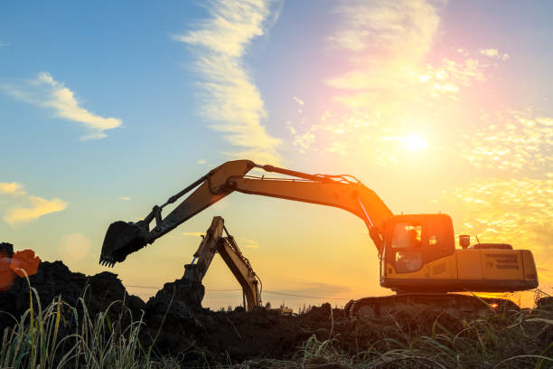istock excavator working on construction site and sunrise landscape 903195122