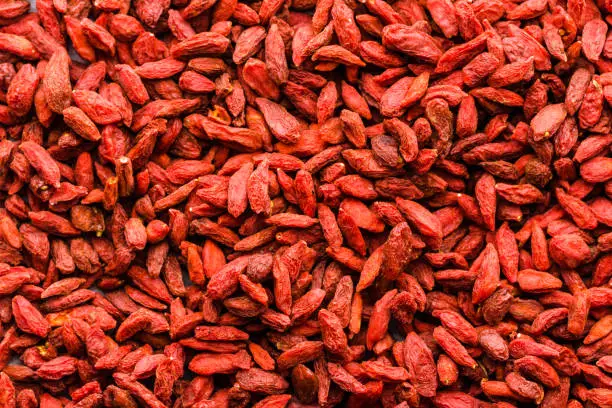 Red background of goji berry, texture of natural dried fruit background with superfood, healthy food ingredient of chinese medicine