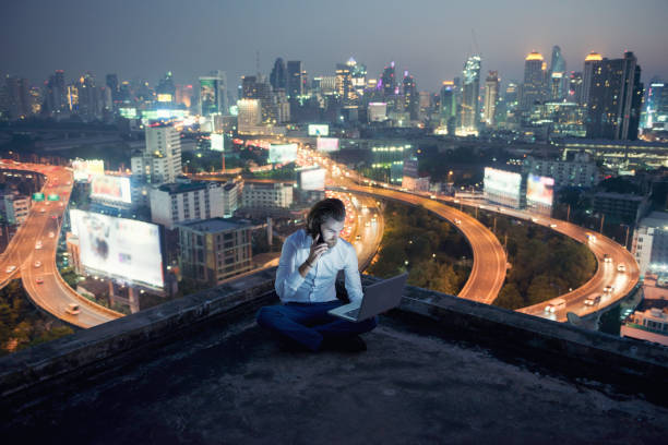 istock Western businessman using phone and laptop with city  background, technology communication concept 903198992