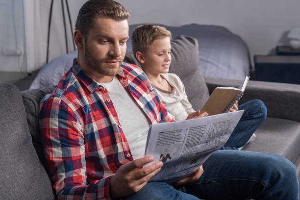 istock father and son reading at home 903205742